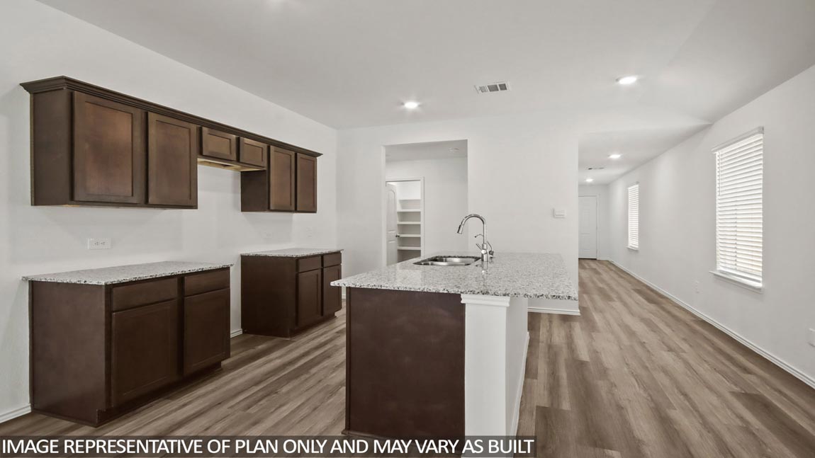 open concept livving and dining area with vinyl flooring, quartz countertops, and large windows in Hockley, TX