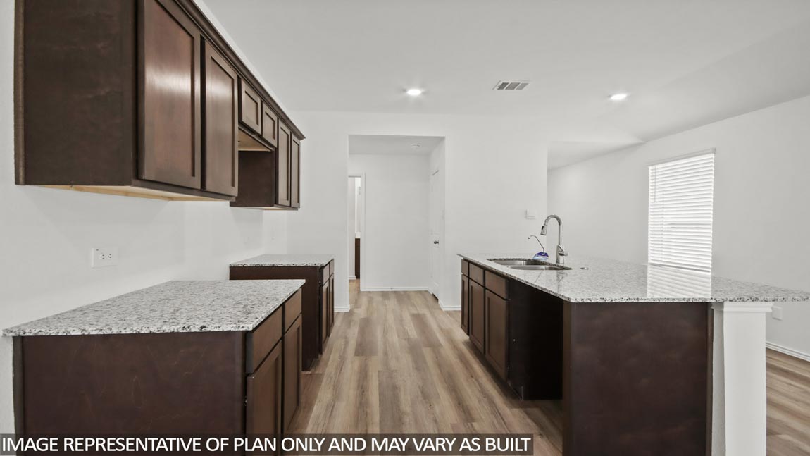 open concept livving and dining area with vinyl flooring, quartz countertops, and large windows in Hockley, TX