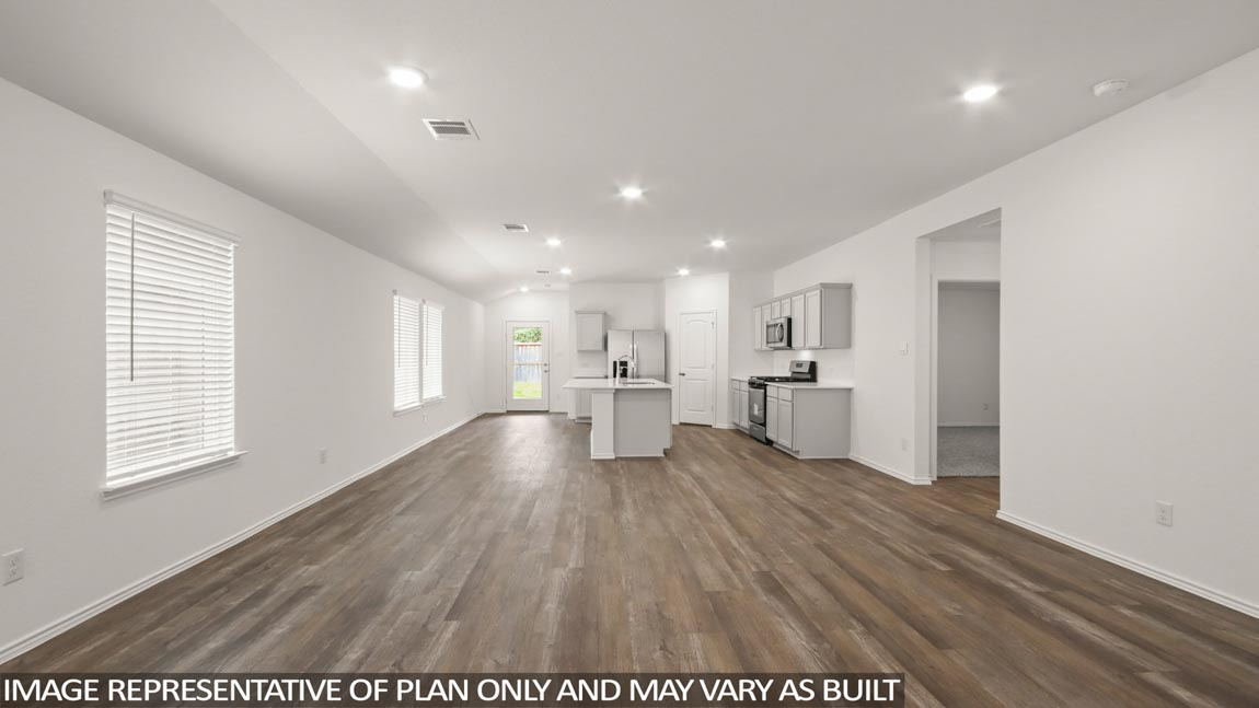 open concept living and dining area with vinyl flooring, quartz countertops, and large windows
