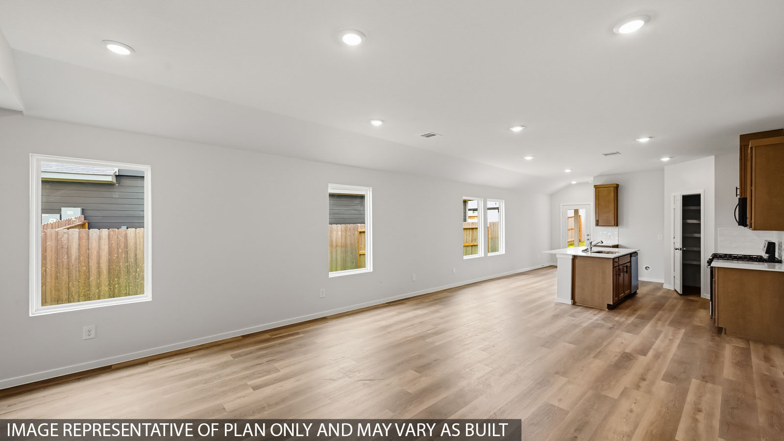 open conccept living and dining area with vinyl flooring and large windows