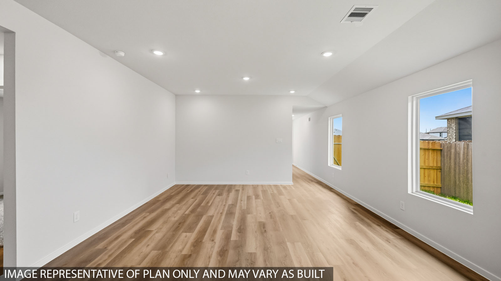 open conccept living and dining area with vinyl flooring and large windows