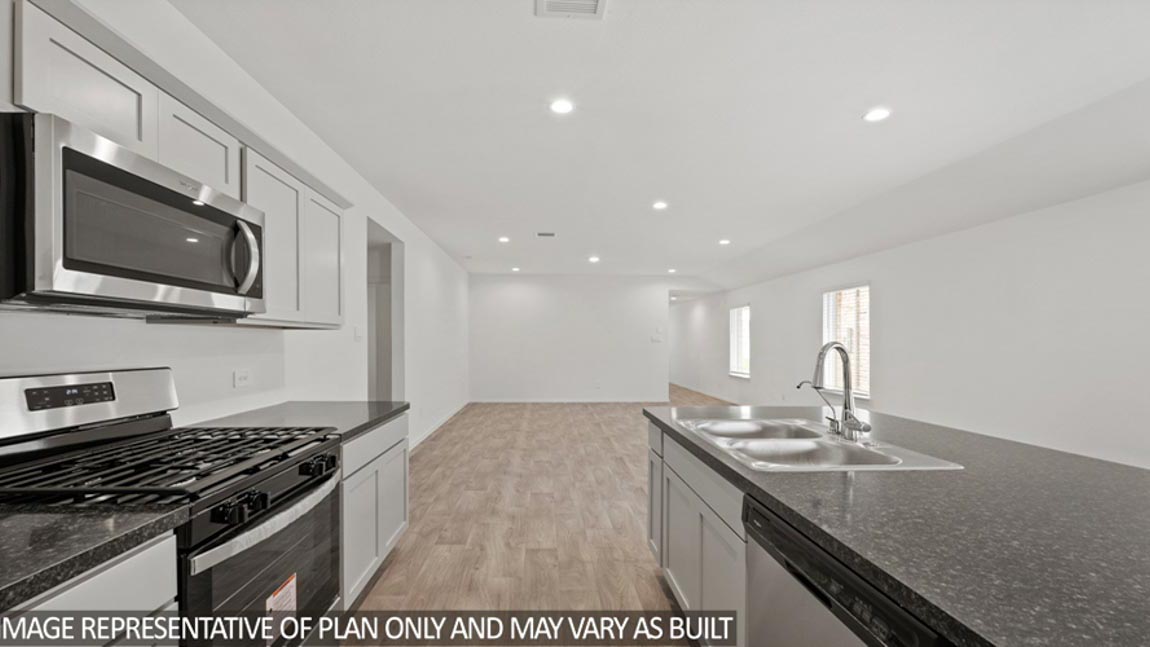 open concept livving and dining area with vinyl flooring, and large windows. Located in Hockley, Texas