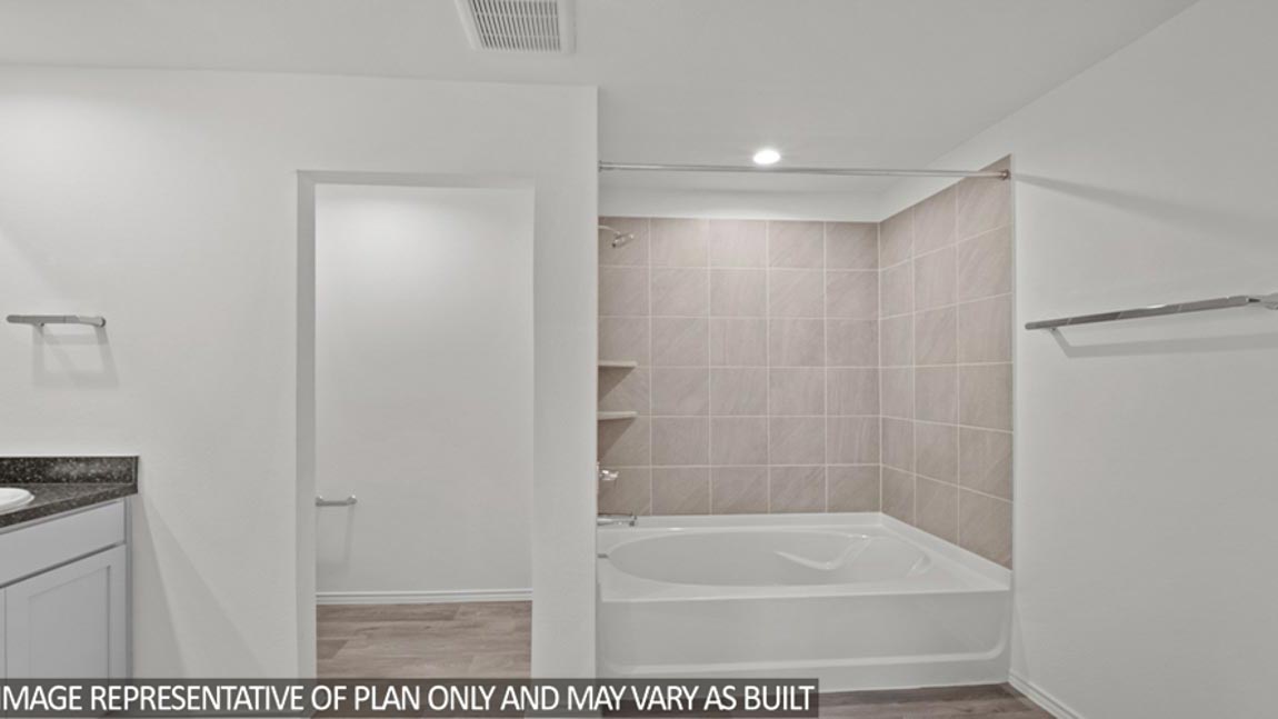 bathroom with tub and shower combo in Hockley, Texas