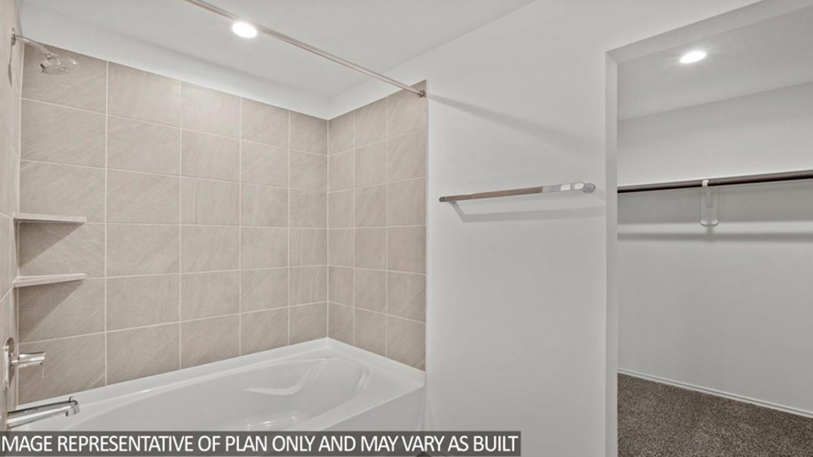 bathroom with tub and shower combo in Hockley, Texas