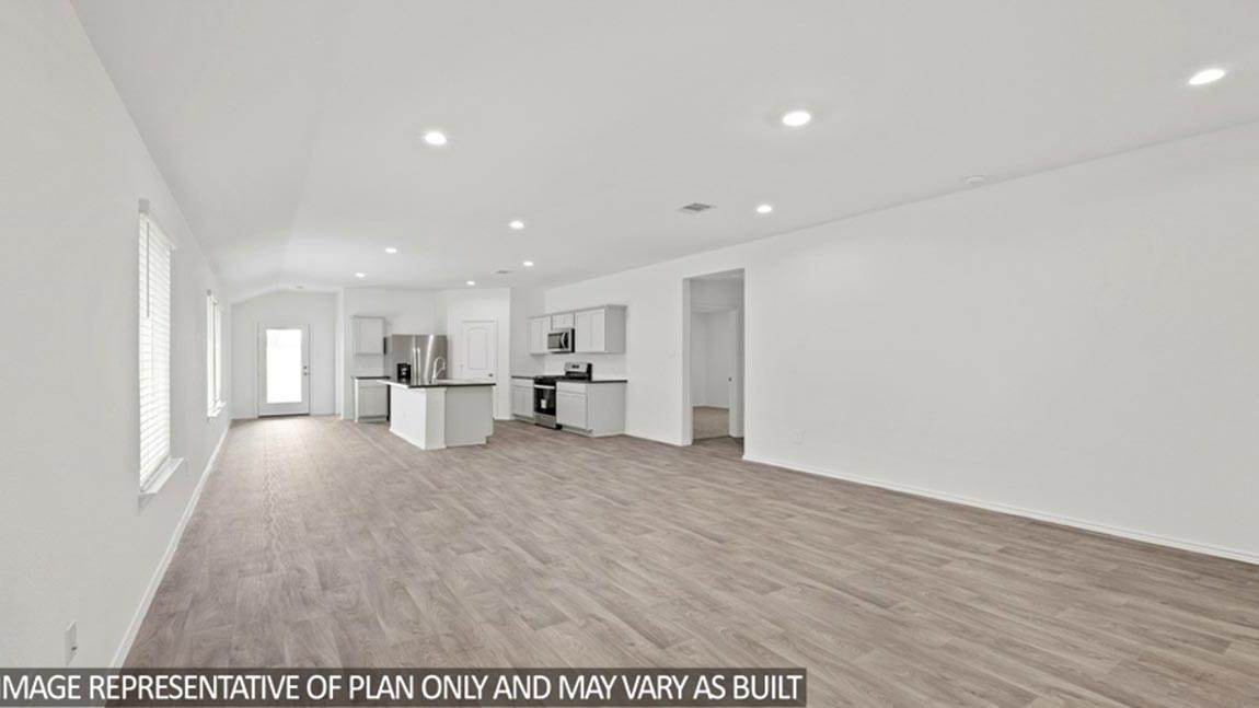 open concept livving and dining area with vinyl flooring, and large windows. Located in Hockley, Texas