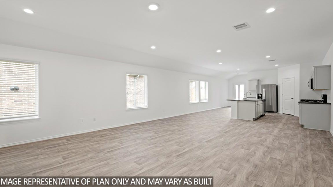 open concept livving and dining area with vinyl flooring, and large windows. Located in Hockley, Texas