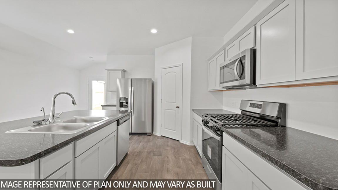 open concept livving and dining area with vinyl flooring, and large windows. Located in Hockley, Texas
