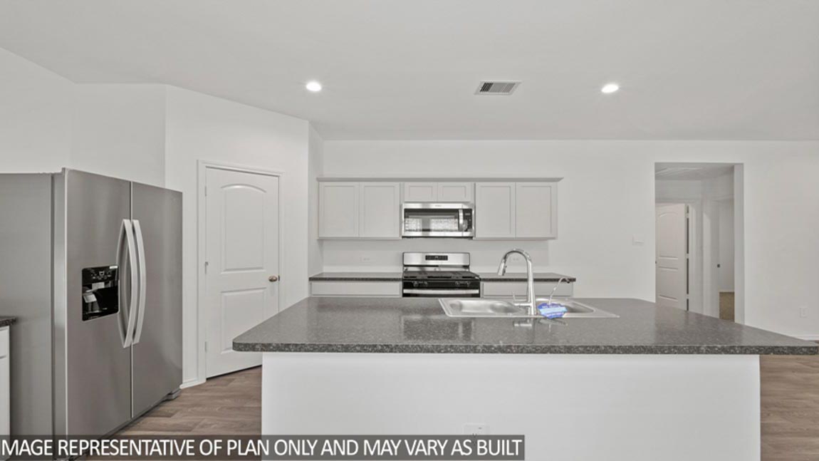 open concept livving and dining area with vinyl flooring, and large windows. Located in Hockley, Texas