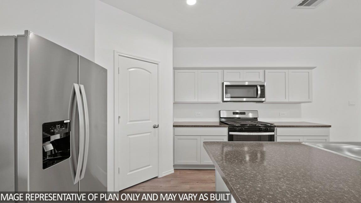 open concept livving and dining area with vinyl flooring, and large windows. Located in Hockley, Texas