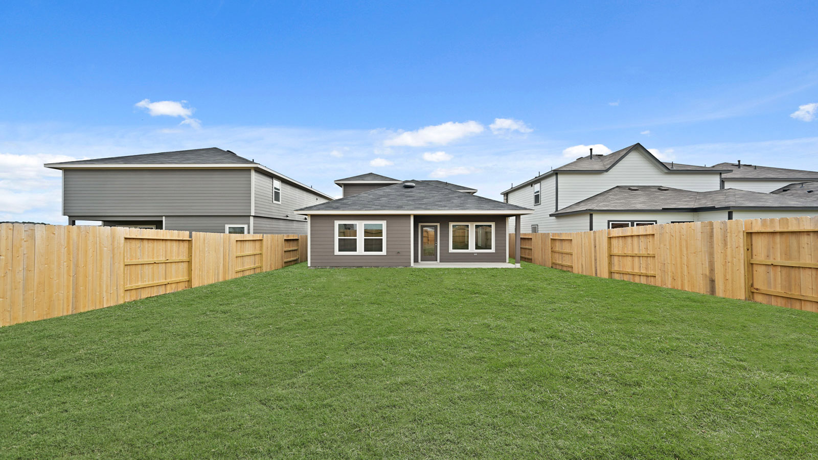 large backyard with covered patio