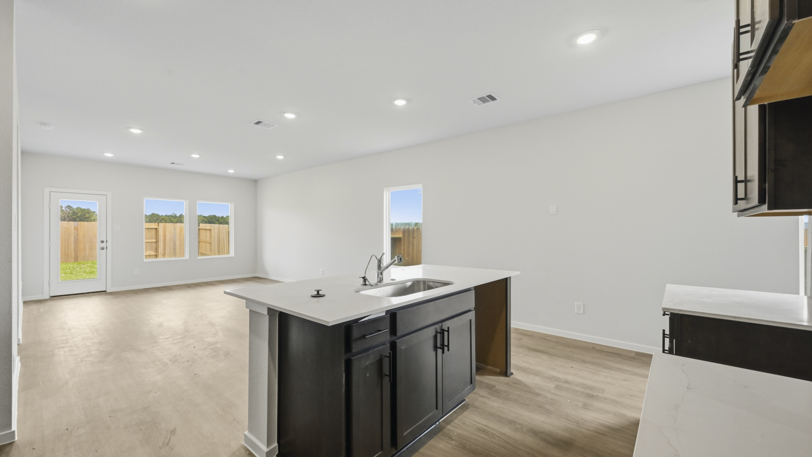 open concept living and dining area with vinyl flooring