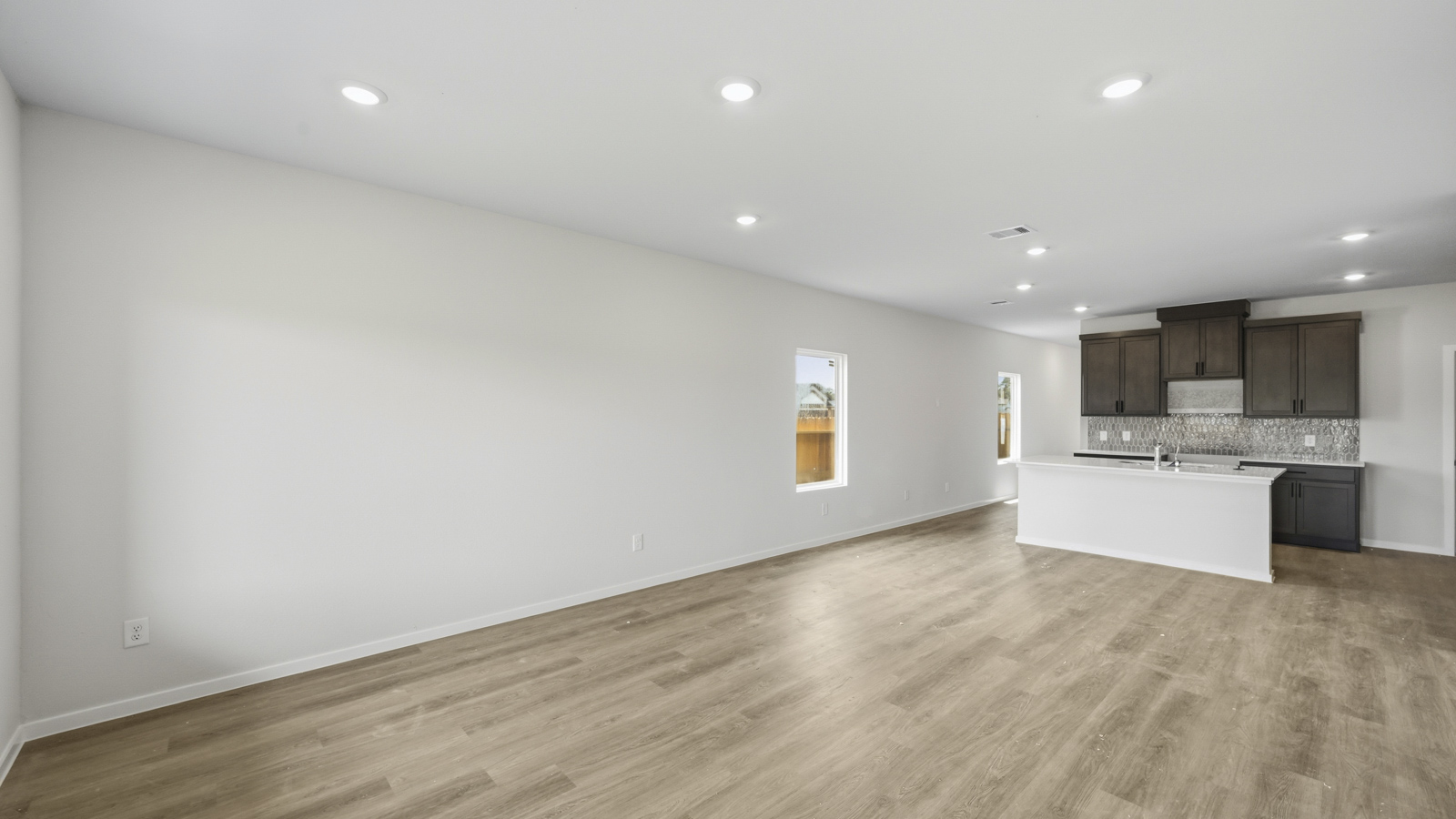 open concept living and dining area with vinyl flooring
