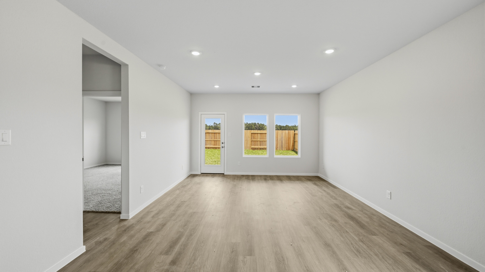 open concept living and dining area with vinyl flooring