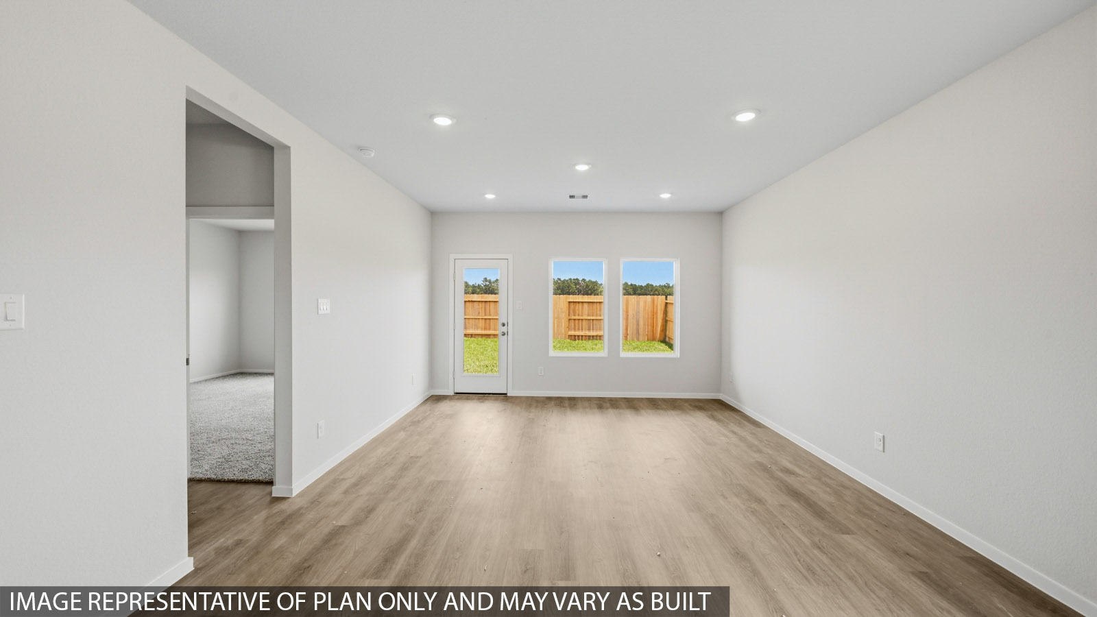 open concept living and dining area with vinyl flooring and large windows