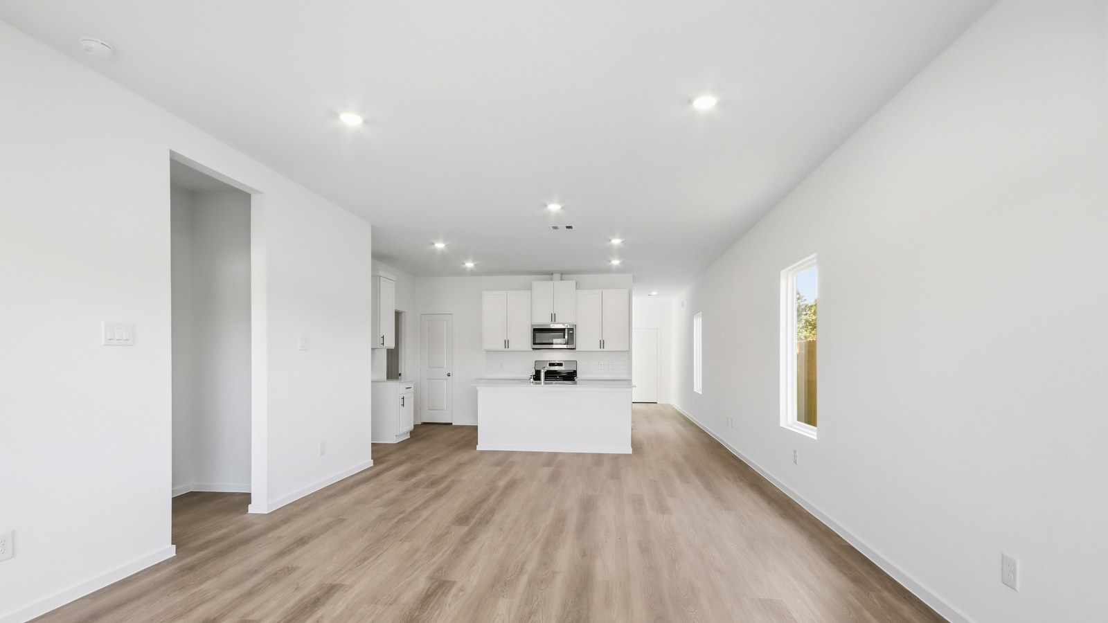 open concept living and dining area with vinyl flooring, and quartz countertops