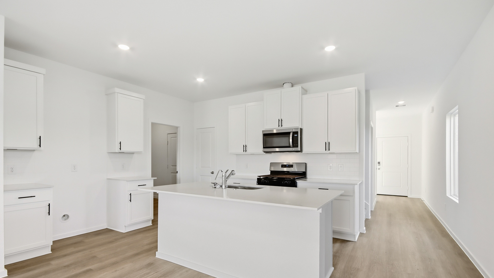 open concept living and dining area with vinyl flooring, and quartz countertops