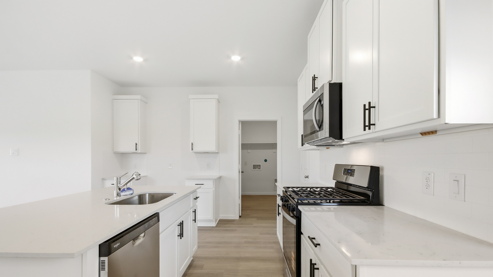 open concept living and dining area with vinyl flooring, and quartz countertops