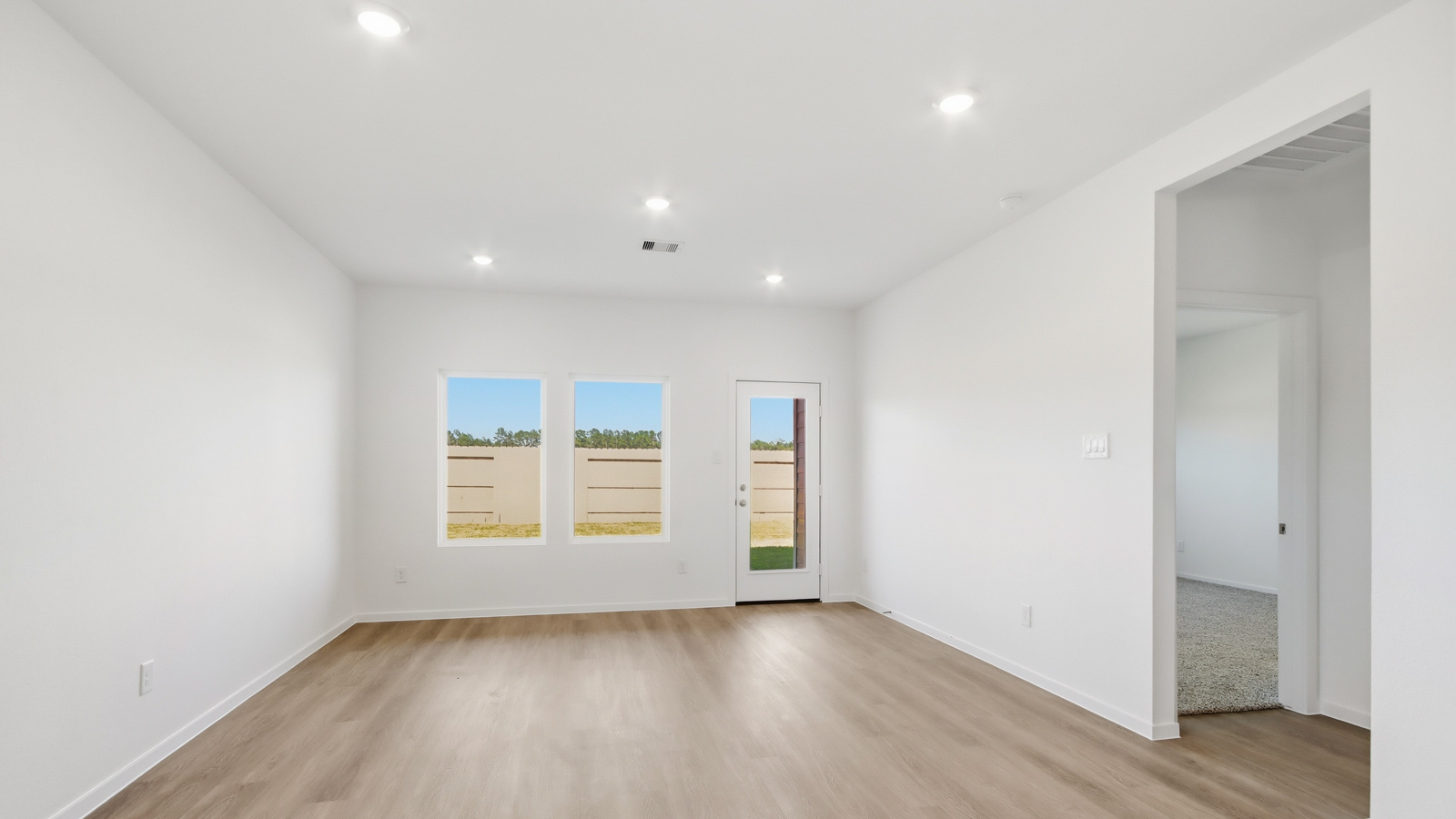 open concept living and dining area with vinyl flooring, and quartz countertops