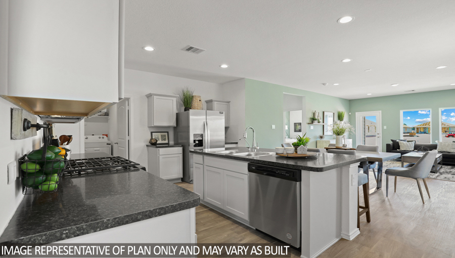 kitchen with stainless steel appliances, quartz cuontertopsn, and kitchen island.