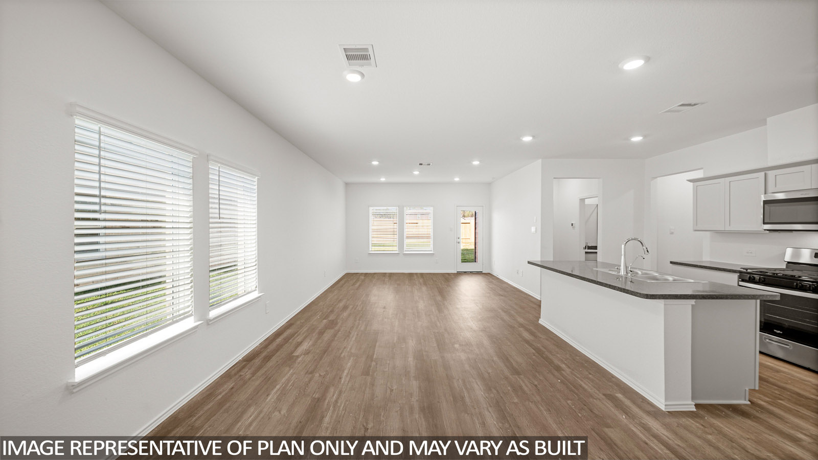 open concept living and dining area with vinyl flooring, quartz countertops, and large windows