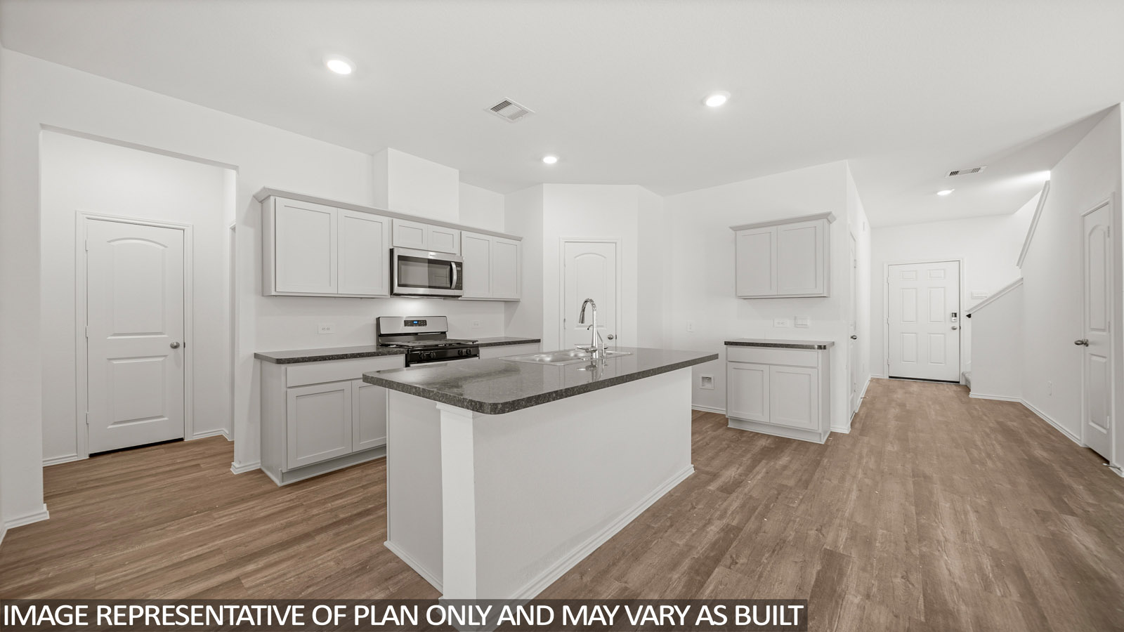 open concept living and dining area with vinyl flooring, quartz countertops, and large windows