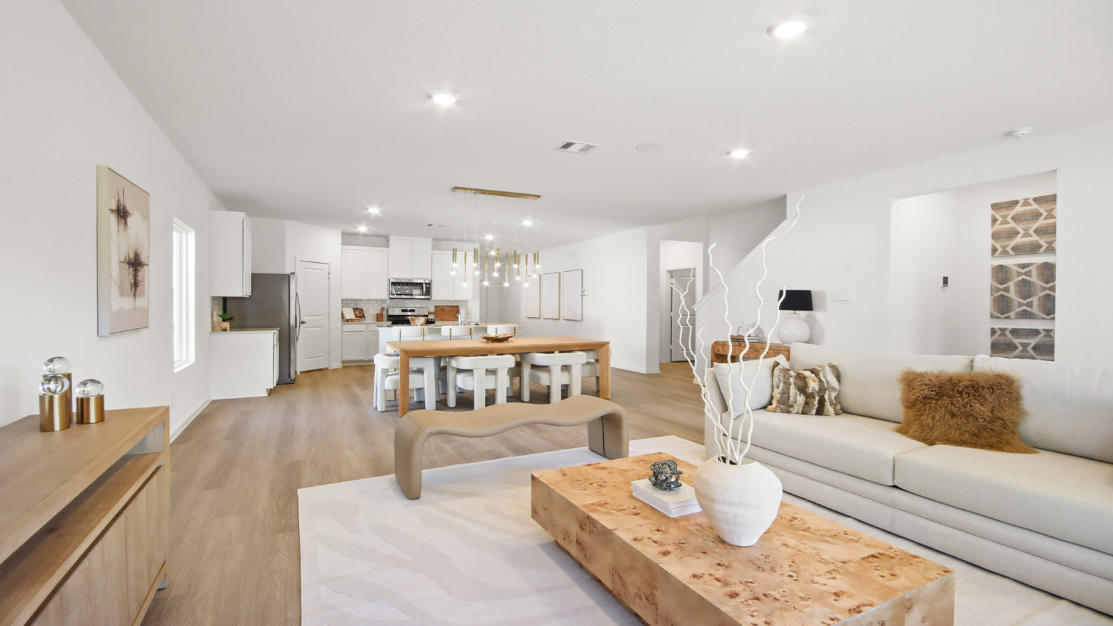 open concept living and dining area with vinyl flooring and large windows