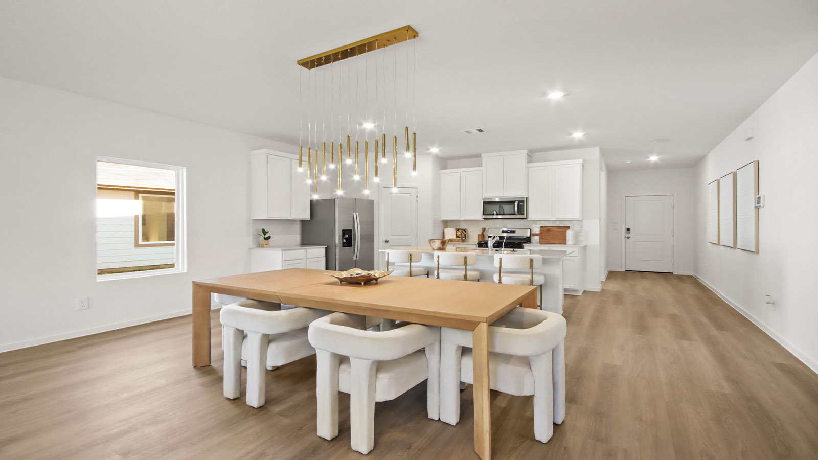 open concept living and dining area with vinyl flooring and large windows