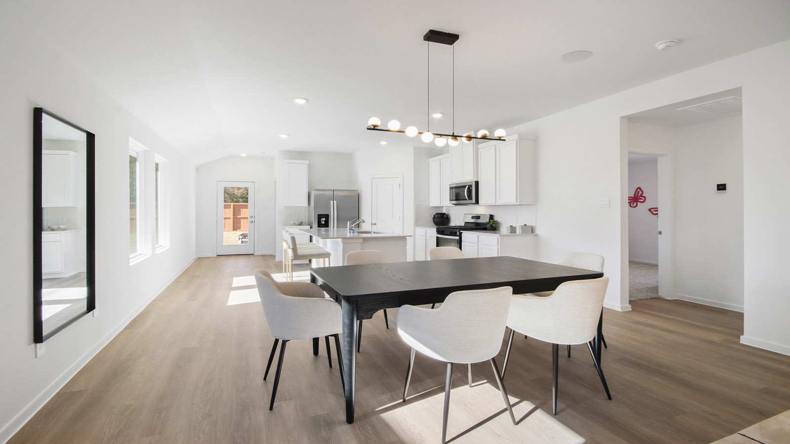 open concept living and dining area with vinyl flooring and large windows