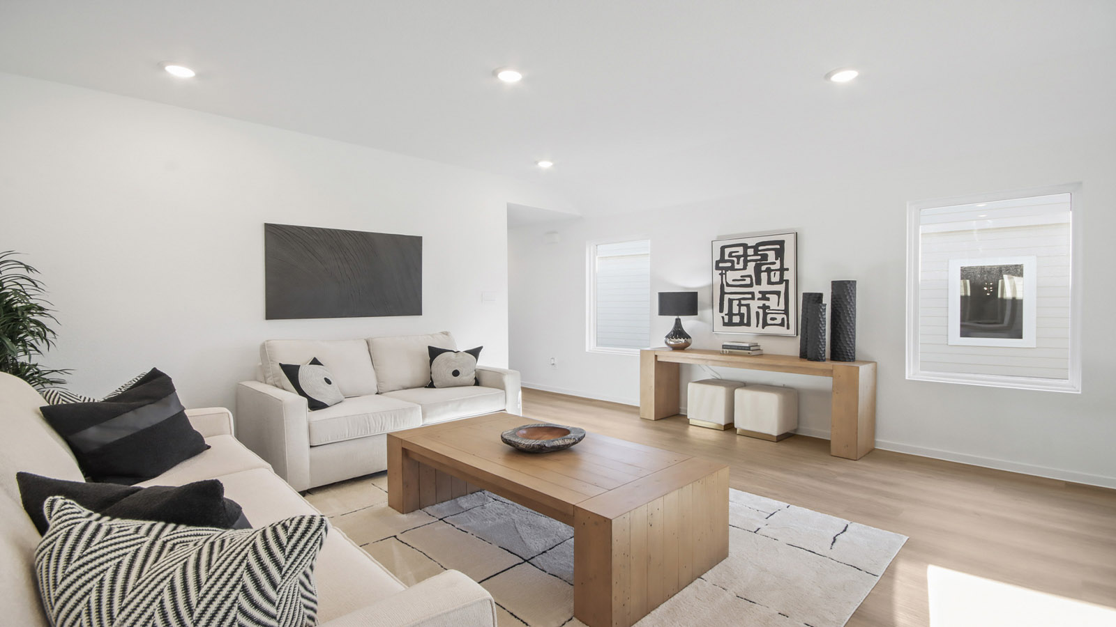 open concept living and dining area with vinyl flooring and large windows