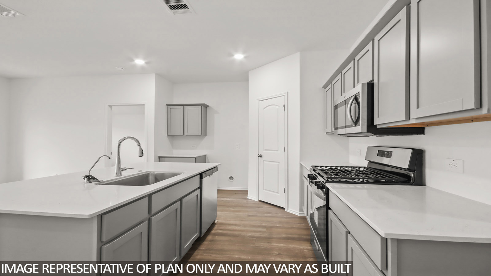 open concept living and dining area with vinyl flooring, large windows, and quartz countertops in Hockley, TX