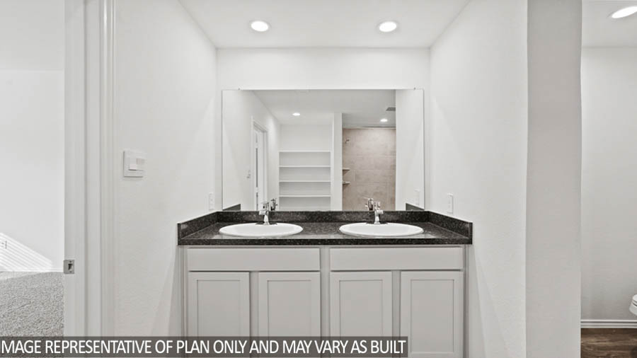 primary bathroom with dual vanities