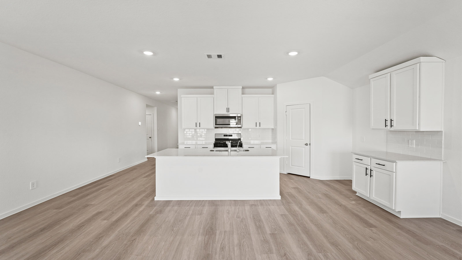 open concept living and dining area with vinly flooring, quartz countertops, and large windows