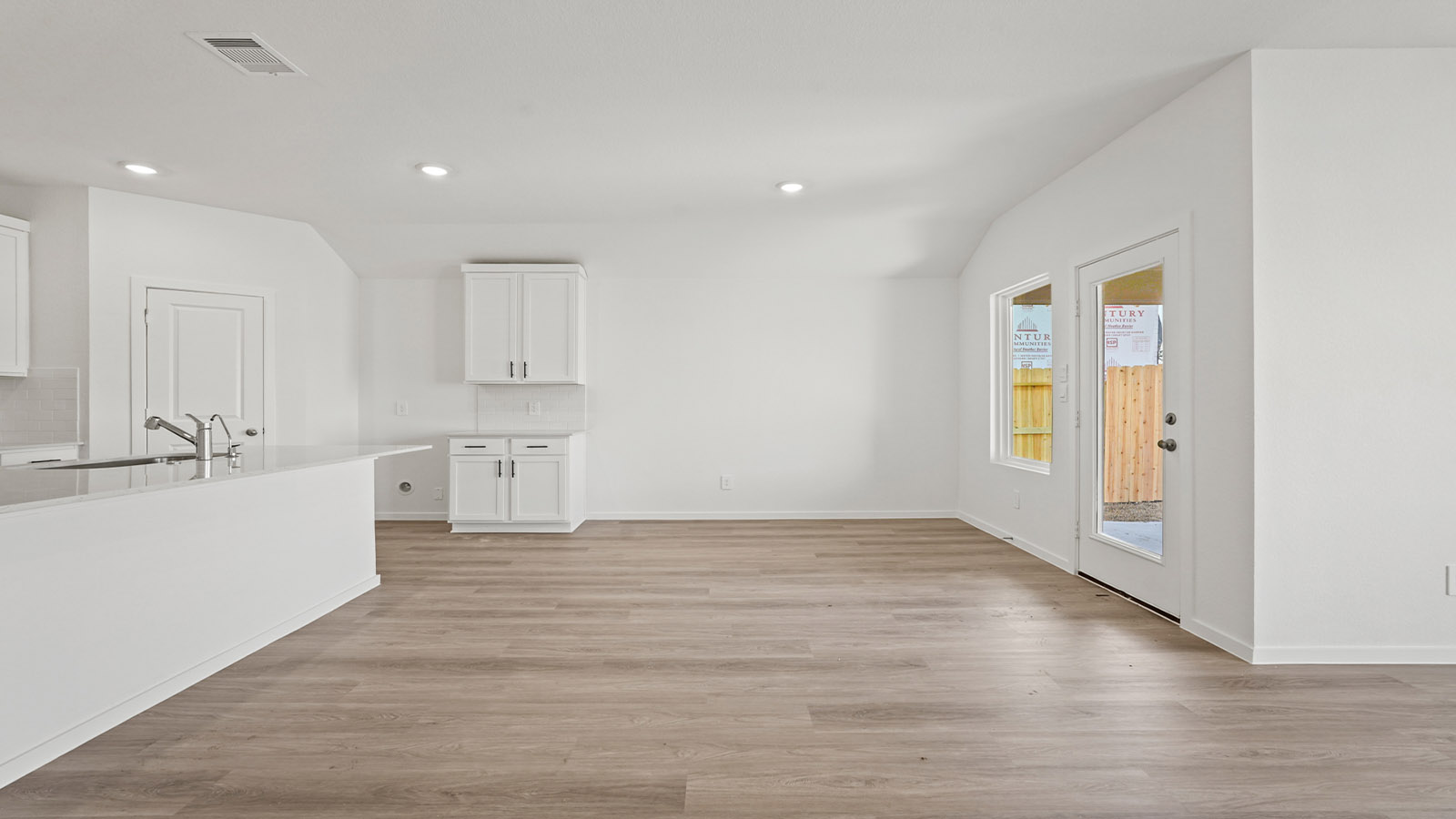 open concept living and dining area with vinly flooring, quartz countertops, and large windows