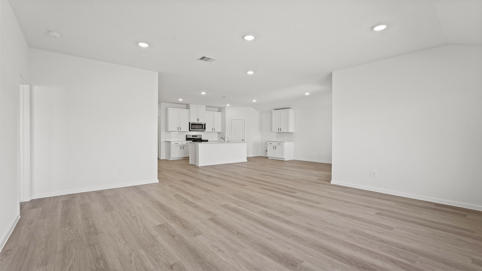 open concept living and dining area with vinly flooring, quartz countertops, and large windows