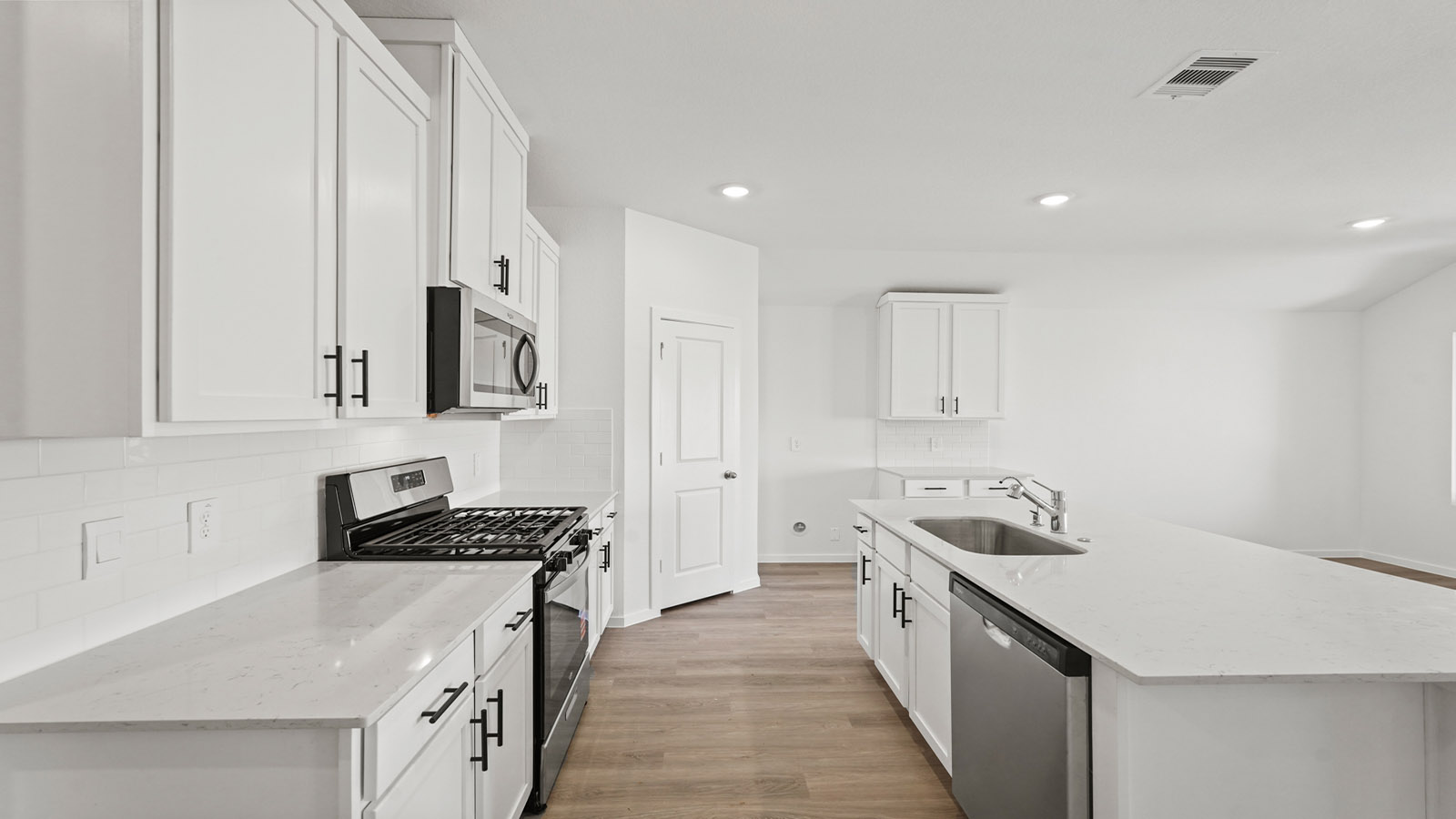 open concept living and dining area with vinly flooring, quartz countertops, and large windows