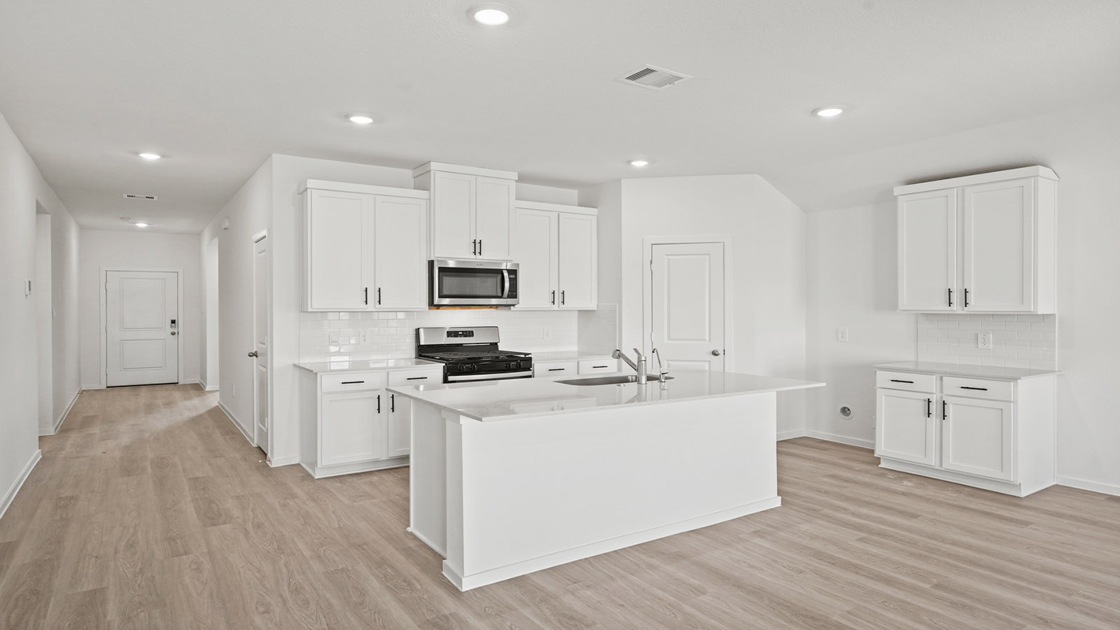 open concept living and dining area with vinly flooring, quartz countertops, and large windows