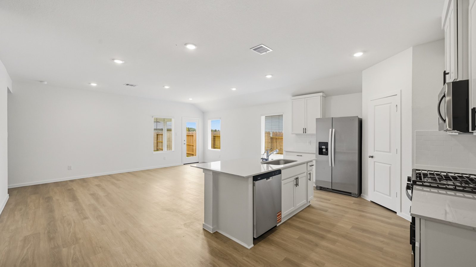 Kitchen with quartz countertops and an island and vinyl floor