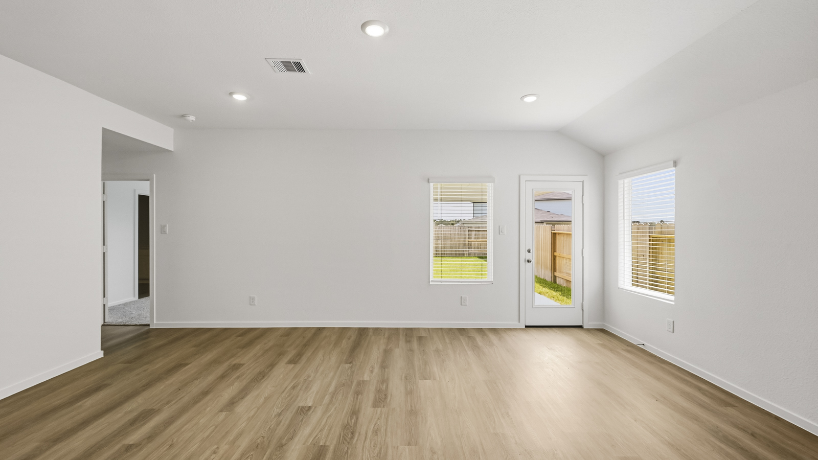 Spacious living area with vinyl flooring and bright windows in Hockley TX