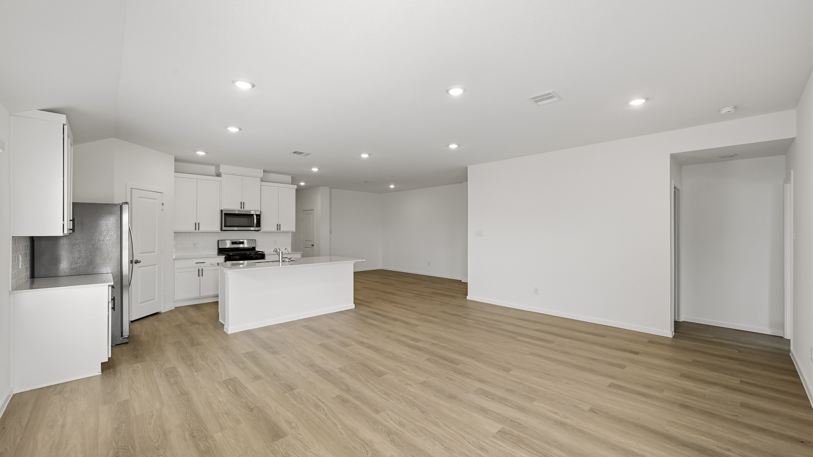 Spacious living area with vinyl flooring and bright windows in Hockley TX