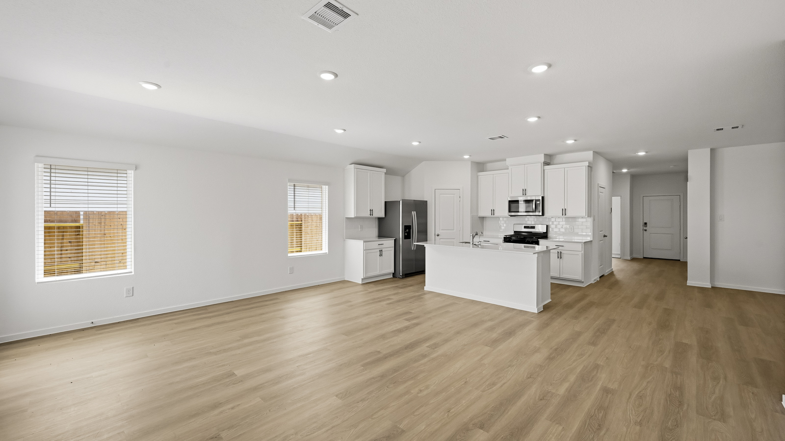Spacious living area with vinyl flooring and bright windows in Hockley TX