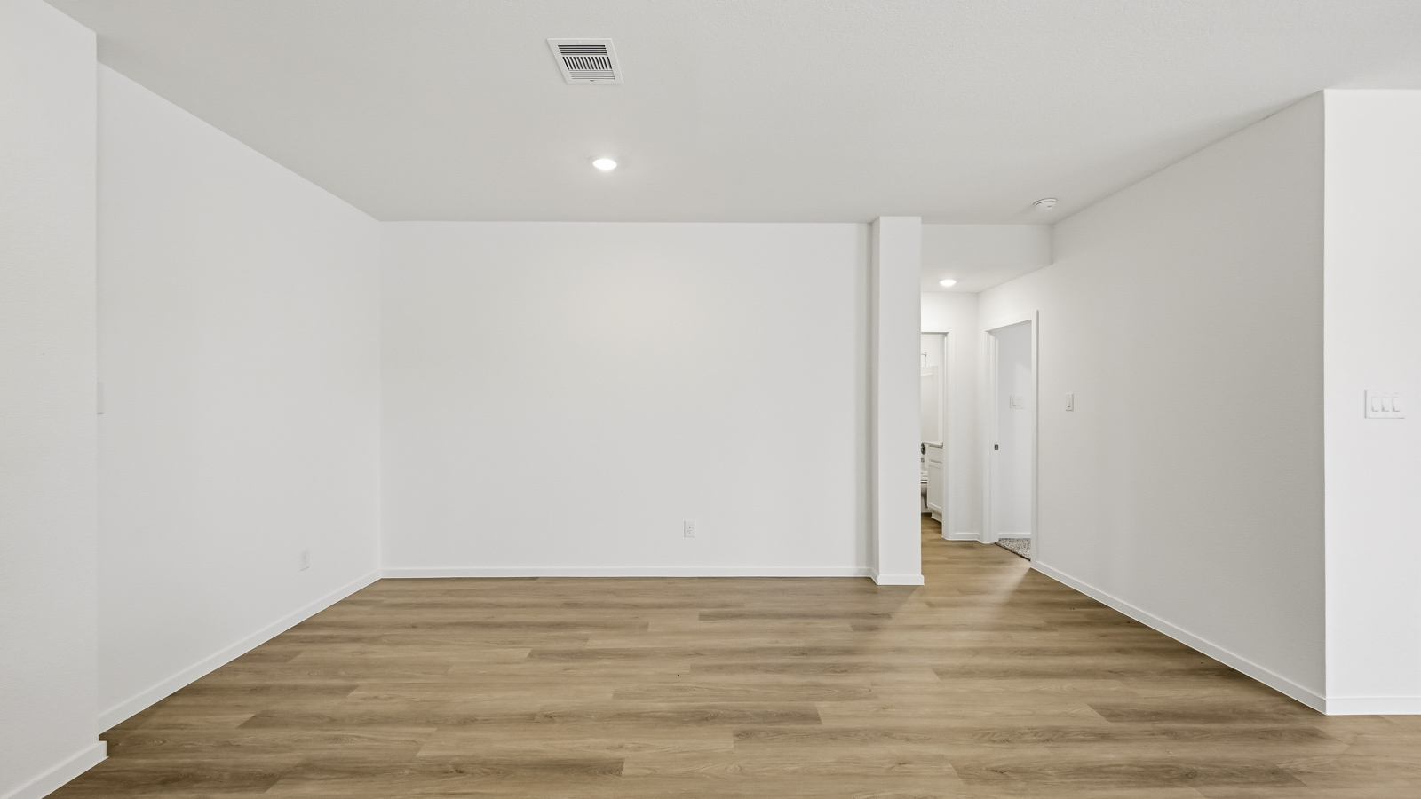 Spacious living area with vinyl flooring and bright windows in Hockley TX