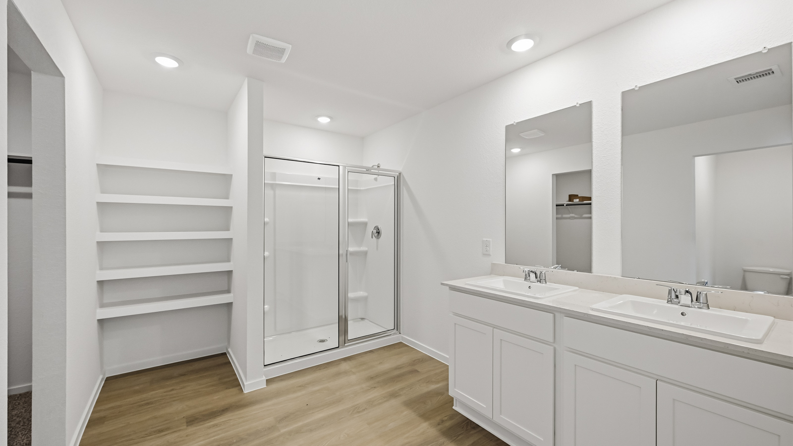 Primary bathroom with soaker tub and tile shower with semi frameless glass in Hockley TX