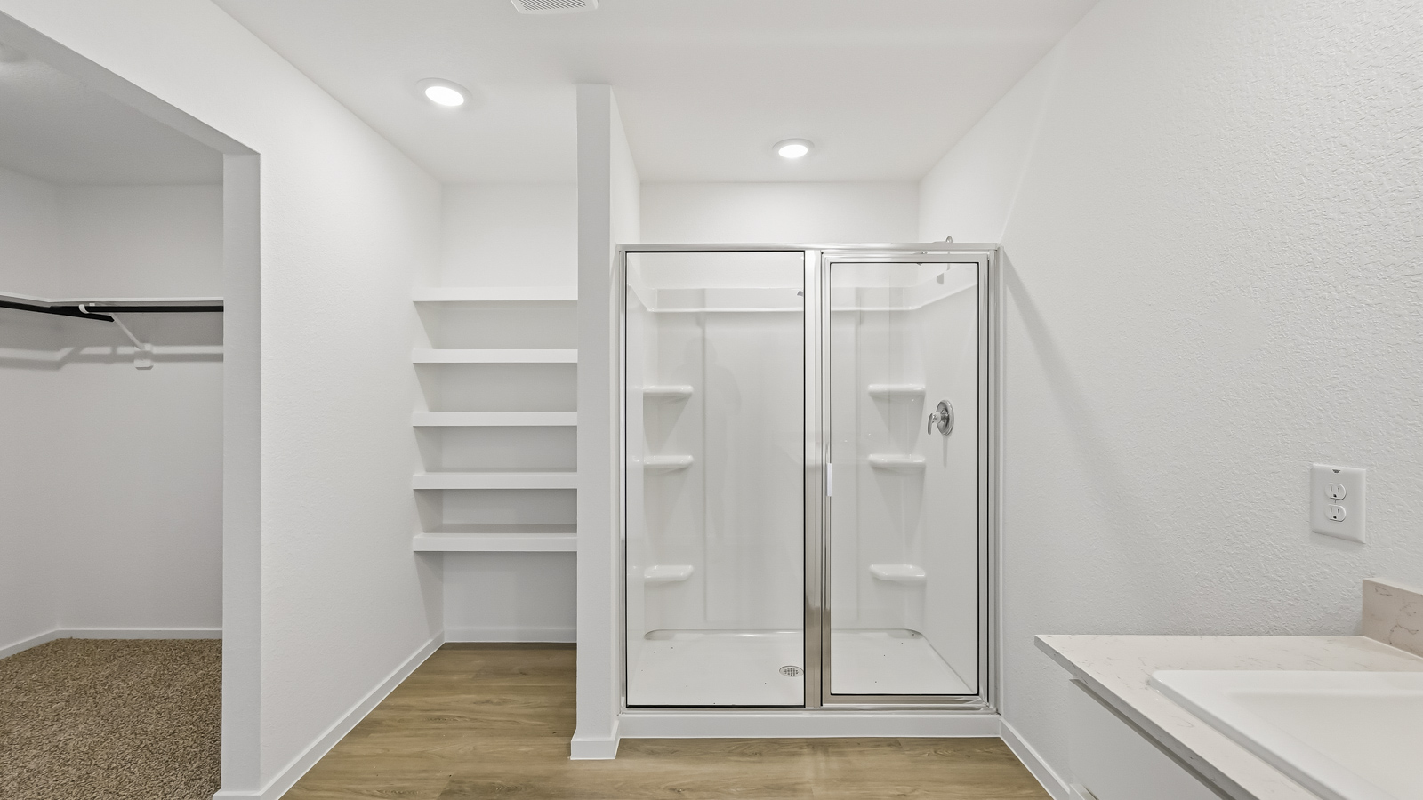 Primary bathroom with soaker tub and tile shower with semi frameless glass in Hockley TX