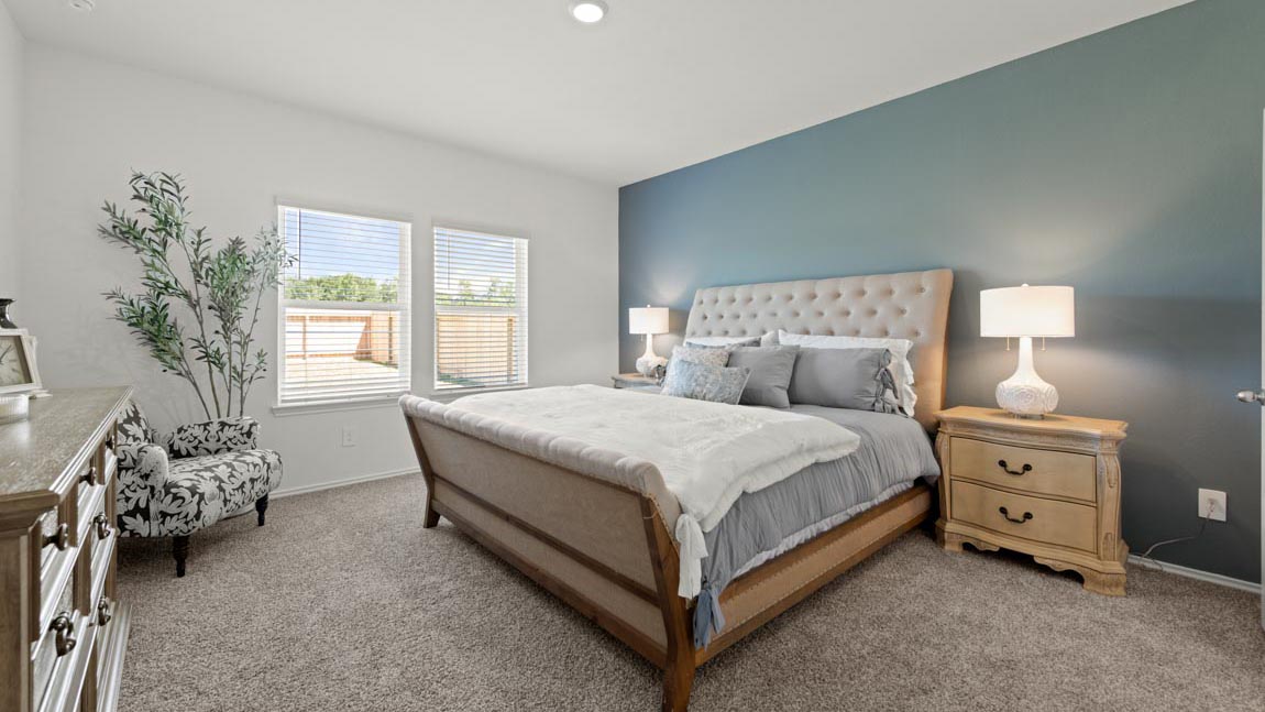 Primary bedroom with carpet flooring and large windows in Hockley, TX
