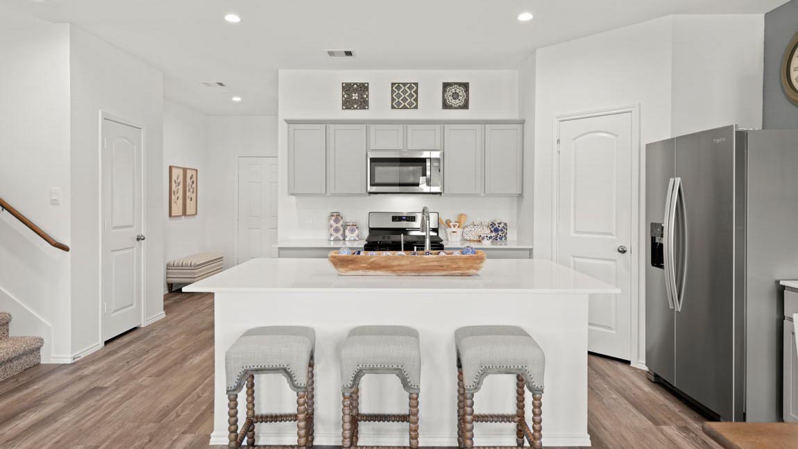 open concept livving and dining area with quartz countertops and stainless steel appliances in Hockley, TX