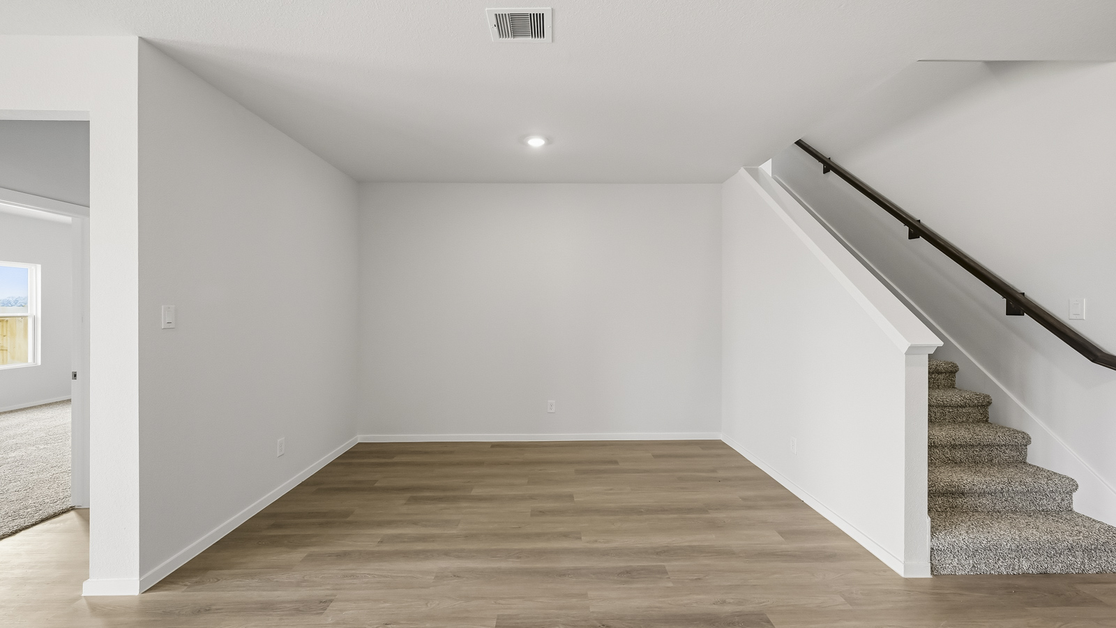 open concept living and dining area with vinyl flooring, large windows, and quartz countertops in Hockley, TX