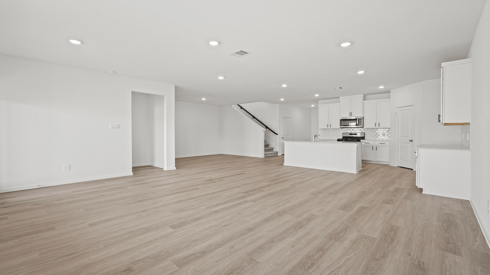 open concept living and dining area with vinyl flooring