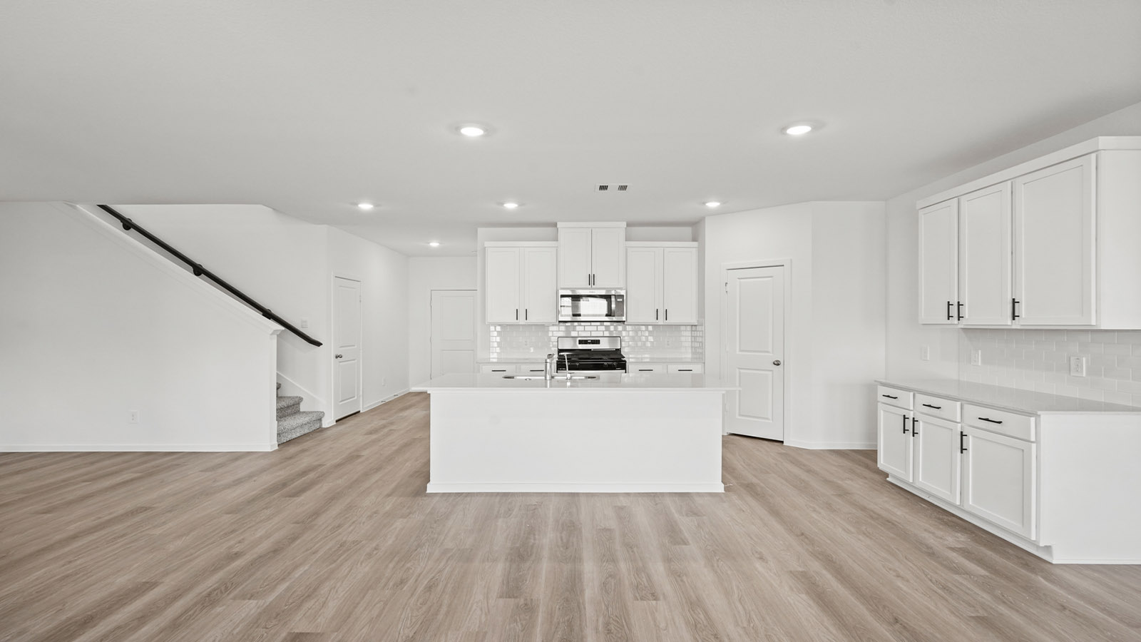 open concept living and dining area with vinyl flooring