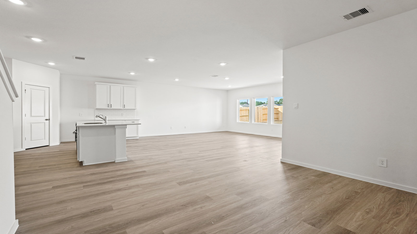 open concept living and dining area with vinyl flooring