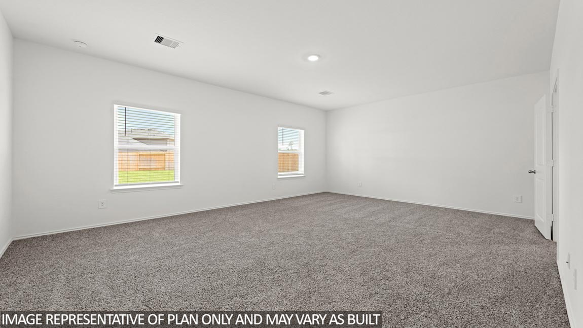 Primary bedroom with carpet flooring